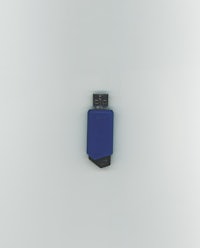 a blue usb drive sitting on top of a white surface