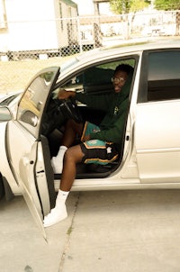 a man sitting in the driver's seat of a car