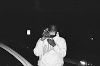 a black and white photo of a man taking a picture
