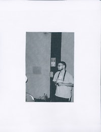 a black and white photo of a man standing in a room