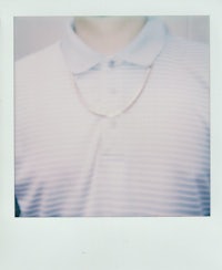 a man is wearing a necklace