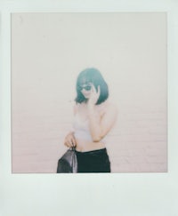 polaroid photo of a woman holding a cell phone