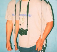 a man holding a camera in front of a mirror